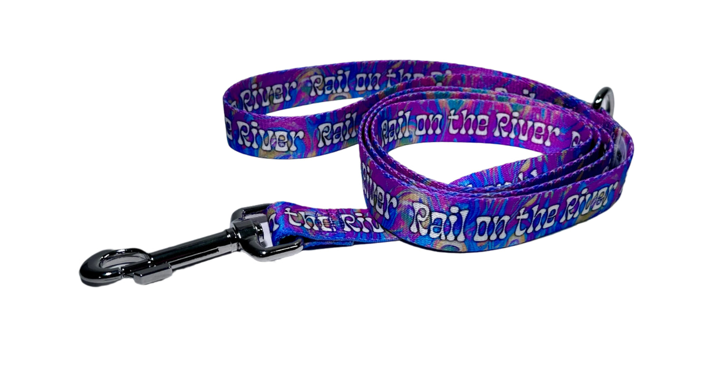 Dog leash with colorful purple pattern and metal clip on a white background